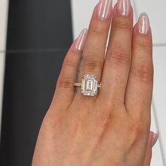 a woman's hand with a ring on it and a diamond in the middle