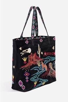 Striking in color and design, the Arizona Everyday Tote adds a statement-making twist to a timeless everyday style. Inspired by the landscape of Arizona, this tote bag is crafted from pure cotton and boasts two patterned top handles, a printed lining, and a colorful placement embroidery complete with floral, star, and cactus motifs. Pair with a flowy dress on your warm-weather getaway or style with pants and a pullover for a playful daytime ensemble. Johnny Was Women's Arizona Everyday Tote Bag Bags Grunge, Style With Pants, Cactus Motif, Placement Embroidery, Everyday Tote Bag, Embroidered Tote Bag, Velvet Clothes, Embroidered Tote, Beach Shop