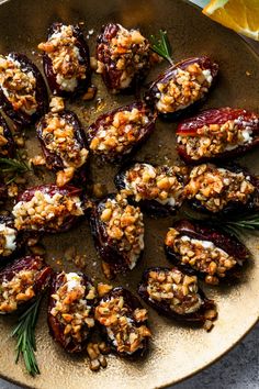 an overhead view of stuffed eggplant with walnuts and feta cheese on a plate