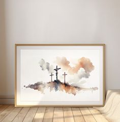 a watercolor painting of three crosses on top of a hill with clouds in the background