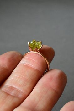 Rough Peridot ring in my best selling lotus flower design. A handcrafted rose gold fill band and cup filled with small rough Peridot gemstones, my signature design. Created to represent a delicate lotus flower. Organic, natural Peridot greens in varying shades look pretty and unique next to the rose gold color. Peridot is August's birthstone and Libra signs. Made to order. Scroll down to read more... I love this ring as an ultra unique, any occasion ring for her! For special gift giving occasion Raw Peridot Ring, Peridot And Opal Ring, Libra Signs, Lotus Flower Jewelry, Peridot Engagement Rings, August Birthstone Ring, Lotus Flower Design, Libra Sign