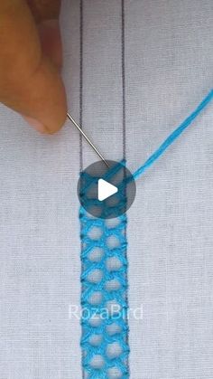 the video shows how to make a crochet necklace with blue thread and beads