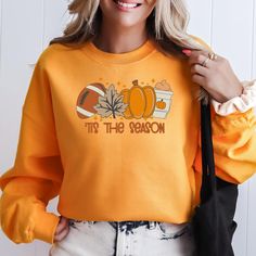 Tis The Season Football Leaves Pumpkin and Coffee Latte Embroidered Pumpkin Fall Sweatshirt Ideal for any situation, a unisex Gilden crewneck sweatshirt is pure comfort. These garments are made from polyester and cotton. This combination helps designs come out looking fresh and beautiful. The collar is ribbed knit, so it retains its shape even after washing. There are no itchy side seams on these sweaters. .: Made with a medium-heavy fabric blend of 50% cotton and 50% polyester (8.0 oz/yd² (271. Tis The Season Football, Embroidered Pumpkin, Leaf Pumpkin, Pumpkin Sweater, Pumpkin Coffee, Sweatshirt Halloween, Coffee Latte, Fall Sweatshirt, Fleece Sweatshirt