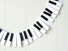 a white and black piano string is hanging on the wall