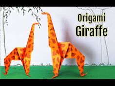 two origami giraffes standing next to each other