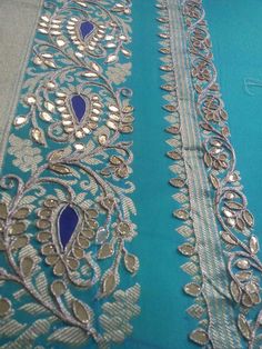 the blue and silver fabric is being worked on