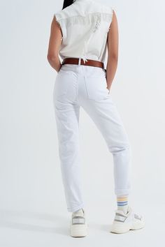 Regular-waist mom jeans with a straight-fit leg, double-turned-up and sewn-in cuffs, and utility pockets on the sides and back, these jeans are comfy and stretchy. Many women prefer adding a belt to mom jeans, which you can do with these because they boast of utility belt loops. The styling options are many; however, we love the dramatic look of pairing these jeans with our Denim Vest in White, as we show in our photos. The fabric is nice and stretch, made from 98% Cotton and 2% Elastane. The mo White Mom Jeans, Types Of Jeans, Sports Bra Top, Stretch Denim Fabric, Utility Belt, Jeans Mom, Mom Jean, Dramatic Look, Denim Vest