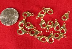 several pieces of metal sitting on top of a red cloth next to a dime coin