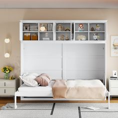 a white bed sitting under a book shelf next to a dresser