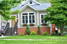 a small house with landscaping in the front yard