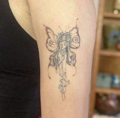 a woman's arm with a butterfly tattoo on the left side of her body