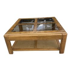 a coffee table with glass top and wicker bottom