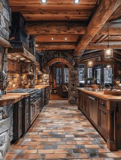 a large kitchen with stone walls and flooring