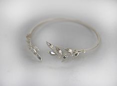 This beautiful arm cuff seems is made out of two twig like leaves, one on each side, along with lots of little pearls. Theleaves are securely soldered on a flexible bracelet base, so it's very easy to adjust the size to fit your arm perfectly. The size is around 10inch/25cm. It could be adjusted to become slightly bigger or smaller. Please make sure to measure you arm before ordering to make sure the size fits. If not be sure to contact me before. * Comes wrapped in a pretty gift bag. * Could be Nature-inspired Wedding Bracelet Jewelry, Nature-inspired Wedding Bracelet, Bracelet Arm, Beautiful Arms, Arm Bracelet, Wire Wrap Bracelet, Flexible Bracelet, Arm Bracelets, Wire Wrapped Bracelet