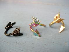 three different types of rings sitting on top of a wooden table next to each other