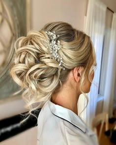 a woman with blonde hair wearing a wedding hairstyle