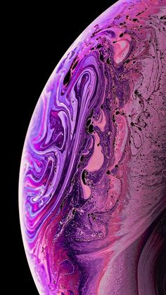 the back side of an iphone with purple and pink swirls on it, against a black background