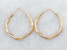 Gold hoops are an essential item in any jewelry collection! These beauties are crafted from 18-karat gold and have a twisted design that catches the light beautifully. Big enough to make a statement, these hoop earrings are also lightweight and perfect for everyday wear. Metal: 18K Yellow GoldMeasurements: 4 x 28 mmMarks: "750 *787" Stamped on the finding Pocket Watch Chain, Watch Chain, Gold Hoops, Gold Hoop, Gold Hoop Earrings, Pearl Pendant, Charm Earrings, Beaded Chain, Shop Necklaces