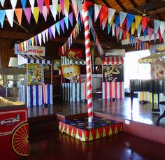 a carnival ride with colorful flags hanging from the ceiling