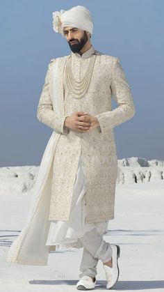 Turn heads with this white sherwani enhanced with embroidery and layered with a plain anarkali kurta. It comes with a white dupatta and a churidar. Shop White Wedding Sherwani For Groom Online at Tathastu. Shipping Worldwide. White And Red Sherwani Indian Groom, White Golden Sherwani Groom, Dulha Collection Men, Anarkali Sherwani Men, Indian Men’s Wedding Attire, Dulha Dresses For Men, Achkan For Men Indian Weddings, Jodhpuri For Groom, Sangeet Dress For Groom