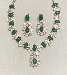 Polki Necklace Set features emerald green Kundan stones with a Sabyasachi-inspired design. Adorned with moissanite and Polki diamonds, it showcases intricate craftsmanship and elegant statement-making. Perfect for weddings, this piece blends traditional Indian artistry with contemporary sparkle, offering a stunning focal point for any bridal ensemble. *𝐏𝐑𝐎𝐃𝐔𝐂𝐓 𝐃𝐄𝐓𝐀𝐈𝐋* * Material: Brass * Plating: Gold Plated * Stone: Semi Precious Kundan & Polki. *𝐃𝐈𝐌𝐄𝐍𝐒𝐈𝐎𝐍𝐒* *  Necklace- Green Temple Jewelry Necklace With 17 Jewels, Festive Emerald Necklace With Intricate Design, Festive Kundan Emerald Necklace With Intricate Design, Green Round Kundan Necklace In Temple Jewelry Style, Green Round Kundan Necklace With Cutdana, Elegant Green Kundan Necklace With Meenakari, Traditional Jeweled Kundan Necklace For Formal Occasions, Green Emerald Temple Jewelry Necklace For Celebration, Green Emerald Necklace For Celebrations, Temple Style