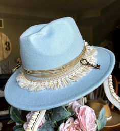 This custom cowboy hat is titled "Baby Blue" and features personalized distressing and accessories that can be found on the hat. The hat contains twine, lace, tassels, and a metal key attached to the side. The cowboy hat is a one-size-fits-most. Please do keep that in mind before purchasing, thanks! Don't miss out on the opportunity of owning this one-of-one piece, it will never be recreated again! Vintage Blue Adjustable Hat Bands, Bohemian Distressed Adjustable Hat Bands, Adjustable Blue Fedora For Western-themed Events, Blue Bohemian Hat For Gift, Blue Bohemian Hat As Gift, Hat Making Ideas, Embellished Cowboy Hat, Custom Cowboy Hats, Boho Hat