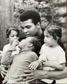 a black and white photo of a man with four children