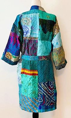 Short Patchwork Cotton Kimono Duster. Expertly designed with quality kantha stitching. This delightful, handmade cotton patchwork kimono is impressive. A full kaleidoscope of colors, blending with all of your basics. Constructed in fresh, quality cotton. Designer influenced and unique. Created as a traditional short kimono with an extra wide front band. Luscious color of turquoise. Can be worn open as a duster jacket or wrapped as kimono. Embroidery is carried through out the garment and finishe Blue Bohemian Kimono With Patchwork, Festival Kimono With Green Patchwork, Festival Green Kimono With Patchwork, Cotton Kimono With Patchwork And Kimono Sleeves, Multicolor Cotton Kimono With Patchwork, Multicolor Cotton Patchwork Kimono, Green Traditional Kimono With Patchwork, Traditional Green Kimono With Patchwork, Handmade Multicolor Cotton Kimono