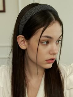 a woman with long hair wearing a headband