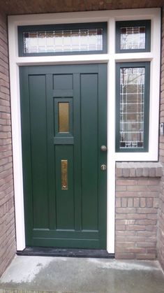 a green front door on a brick building