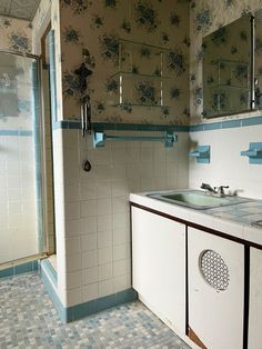 a bathroom with blue and white tile on the walls