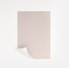 the corner of a piece of paper is shown with a white wall in the background