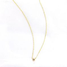 This beautiful trio baguette necklace features a classic design made of three glittering baguettes surrounded by a shiny gold plated chain. It's the perfect accessory for any occasion, sure to add a sparkle to your look. Minimalist Gold Baguette Cut Necklace, Gold Minimalist Charm Necklace For Party, Minimalist Gold Charm Necklace For Party, Gold Baguette Diamond Necklaces For Gift, Gold Necklaces With Baguette Diamonds As Gift, Gold Baguette Cut Diamond Necklace Gift, Gold Necklaces With Baguette Diamonds For Gifts, Elegant Gold Necklace With Baguette Diamonds, Minimalist Gold Diamond Necklace With Baguette Cut