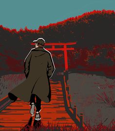 a man walking down a wooden walkway next to a red gate