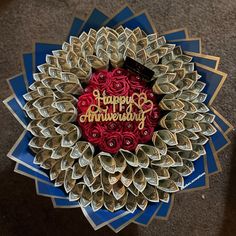 a happy anniversary card made out of rolled up paper and folded into a flower arrangement