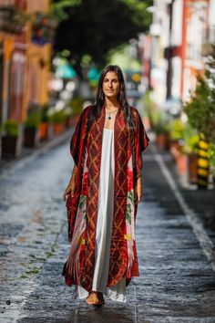 The Mystic Red Rose Silk Kimono is made out of the highest quality of satin silk. It is an extravagant expression of the Rose Priestess within each woman and brings out her radiance. The long back of the Kimono goes to the feet and has a full image of the sacred Red Rose depicted with white wings on it. The bottom of the front part of the silk Kimono is rounded up to allow more flow in the fabric. This piece is a master art piece with Digital Art designed by Phoenix Zafirah. The Red Rose represe Festive Traditional Maxi Kimono, Traditional Festive Maxi Length Kimono, Elegant Red Festive Kimono, Festive Traditional Maxi Length Kimono, Bohemian Festive Maxi Length Kimono, Bohemian Maxi Length Kimono For Festive Occasions, Festive Bohemian Maxi Length Kimono, Bohemian Floor-length Kimono For Festive Occasions, Festive Floor-length Bohemian Kimono