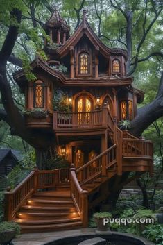 a tree house in the woods with stairs leading up to it's second story