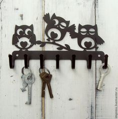 an owl and two owls on a key rack with keys hanging from it's hooks