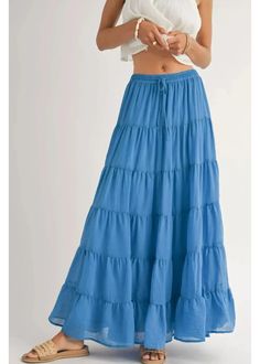 Smocked drawstring waist maxi skirt with many tiers, and a matching lining. Pair with a white tank, cowboy hat, and funky shoes for a concert this summer! Coastal Tiered Maxi Skirt: Blue 100% Polyester Lining Cheap Green Tiered Skirt, Cheap Tiered Beach Bottoms, Cheap Lined Tiered Skirt, Cheap Light Blue Long Skirt, Cheap Fun Blue Bottoms, Cheap Ruffled Maxi Skirt, Cheap Ruffled Beach Skirt, Affordable Blue Bottoms For Beach Season, Cheap Tiered Gathered Maxi Skirt