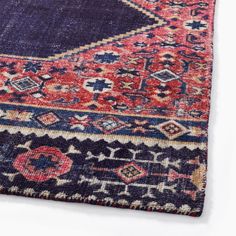 an old persian rug with blue, red and orange colors on it's edges