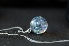 "This is the original fairy bubble necklace - the first, and the rainbowiest. A globe of fairy bubbles... beautiful, beautiful rainbow bubbles that change colour as they catch the light from different angles; the bubbles are swirling throughout the necklace, all different sizes, like they've just been blown. We have captured something as fleeting as bubbles, and made them keepable for always <3 They are available in 2 sizes: 21mm across, and its diddy little sister, who is just 15mm across. Tiny Rainbow Color Necklace For Gift, Magical White Jewelry As Gift, Magical White Jewelry As A Gift, Unique Party Necklaces, Magical Iridescent Necklace Gift, Iridescent Round Necklace For Gifts, Iridescent Round Necklace For Gift, Fairy Bubbles, Faery Jewelry