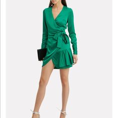 Brand New, Just Tried On. Exclusive-To-Intermix. Effortlessly Luxurious, This Emerald Satin Wrap Dress Was Designed For Partying, Lounging, And Capturing The Hearts Of Admirers. A Charming Ruffle Hem Ensures All Eyes Are On You. Wear Yours With A Pair Of Nude Heels And A Tangle Of Delicate, Sparkly Necklaces. Crossover V-Neck. Attached Wrap Belt Closure At Side Waist. Long Sleeves With Gathered Buttoned Cuffs. Unlined. In Emerald Green. Style Number: Komosa-Excl Fabric: 86% Rayon/14% Polyester L V-neck Midi Dress With Tie Waist For Party, Spring Satin Wrap Dress For Night Out, Satin Tie Waist Dress For Night Out, Satin Dresses With Tie Waist For Night Out, Satin Dress With Tie Waist For Night Out, Chic Tie Waist Mini Dress For Cocktail, Flirty Tie-waist Dress For Date Night, Evening Mini Dress With Tie Waist And V-neck, Evening Mini Dress With Tie Waist