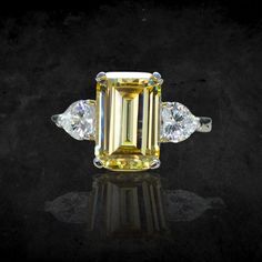 "Personally Designed Art Deco ring in sterling silver. Main gemstone size: 12*8mm Main Stone: Citrine Side Stone: Clear Topaz It's made of fine (solid) sterling silver that is polished and dipped in Rhodium. It has a bright finish and it doesn't tarnish. This classically designed ring is made with beautifully citrine with Emerald cut. Solid and thick band with a professional finish. You will not be disappointed with this beautiful ring. 💎 Gem Stone: Lab treated Yellow citrine with emerald cut. Yellow Topaz Ring With Center Stone In Sterling Silver, Yellow Sterling Silver Crystal Promise Ring, Yellow Sterling Silver Promise Ring, Elegant Yellow Sapphire Sterling Silver Ring, Elegant Yellow Sterling Silver Birthstone Ring, Yellow Diamond Ring With Gemstones In Sterling Silver, Yellow Diamond Ring In Sterling Silver, Yellow Citrine Ring With Brilliant Cut, Fine Jewelry Yellow Diamond Promise Ring