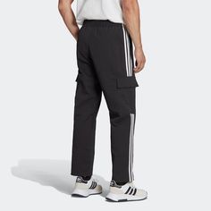 Fashion meets function with these adidas cargo pants. A tried and true style gets updated with ripstop material and tactical pockets that are perfect for storing your goods. Pair them with a favorite tee or jacket, and get out there. From checking the mail to hitting the road, you'll be ready. The adjustable closures at all points ensure the perfect fit. Loose fit. Elastic waist with drawcord. Side zip pockets and cargo pockets with snap buttons. Bungee adjustable hems. Made with recycled materi Adidas Cargo Pants, Adidas Cargo, Adidas Originals Logo, Adidas Adicolor, Adidas Fashion, Adidas Originals Mens, Mens Lifestyle, Cargo Joggers, Tried And True