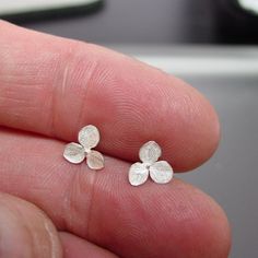 "These are the smallest, sweetest studs I make. Made of sterling silver, they have a satiny, silver white finish in the recessed areas and the tiny raised veins of the petal are burnished to highlight the silver. They look very much like the white hydrangeas when they are in bloom. Very delicate. Great gift idea. They measure just 5/16\" wide (8.10 mm) from point to point. Finished with heavy weight sterling silver posts and ear-nuts. Please read listing description and view all photos to accura Small Flower Earrings, White Hydrangeas, Flower Stud Earrings, Flower Stud, Small Earrings Studs, Hydrangea Flower, Flower Earrings Studs, Flower Studs, Design Silver