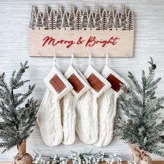 christmas stockings hanging from hooks on a wall