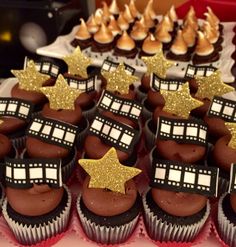 chocolate cupcakes decorated with gold stars and dr who's in the house decorations