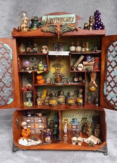 an old fashioned wooden cabinet with many items on it's shelves and decorations around the doors