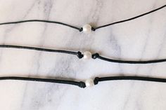 100% vegan pearl choker with your choice of 1mm dainty black cotton cord, 2mm black cotton cord or super soft 3mm vegan suede Choker is 13 inches with a 2 inch adjustable extender chain Looking for a different length? Message me for a custom necklace! Handmade with love by Amanda **please read my shop's policies** Thanks for viewing! 🐚 Minimalist Choker With Adjustable Length, Adjustable Minimalist Choker, Adjustable Length Minimalist Choker, Handmade Gift Tags, Pearl Choker, Reusable Bags, Cotton Cord, Custom Necklace, Necklace Handmade