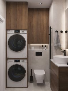 a washer and dryer in a bathroom with wood paneling on the walls